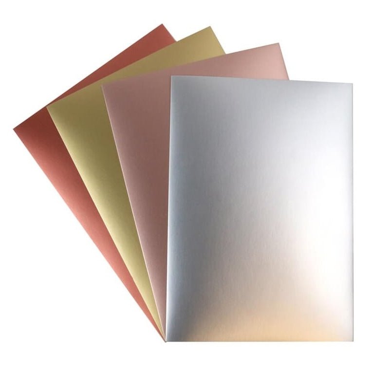 Eight Dovecraft A4 Smooth Metallic Card sheets by Printable Heaven (DCBS207) in assorted finishes are fanned out on a white background—perfect for papercraft projects.