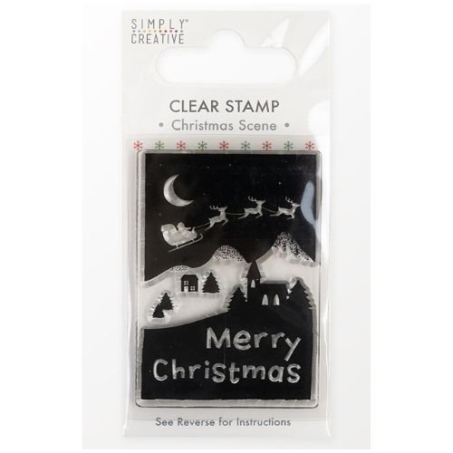 The Printable Heaven Simply Creative Mini Clear Stamp - Christmas Scene (SCSTP043X21) is a 7cm tall set featuring Santa’s sleigh and reindeer flying above snowy mountains, trees, houses, with “Merry Christmas” at the base.