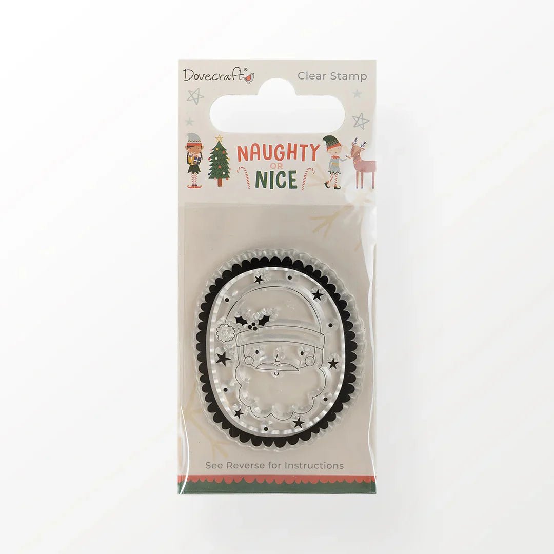 The Printable Heaven Dovecraft Naughty or Nice Clear Stamp (DCSTP190X21) features an oval Santa face and festive elves, tree, and reindeer packaging that reads "NAUGHTY OR NICE." Ideal for scrapbooking or journaling.
