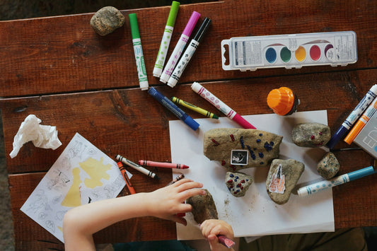 Crayons, paints, rocks and paper