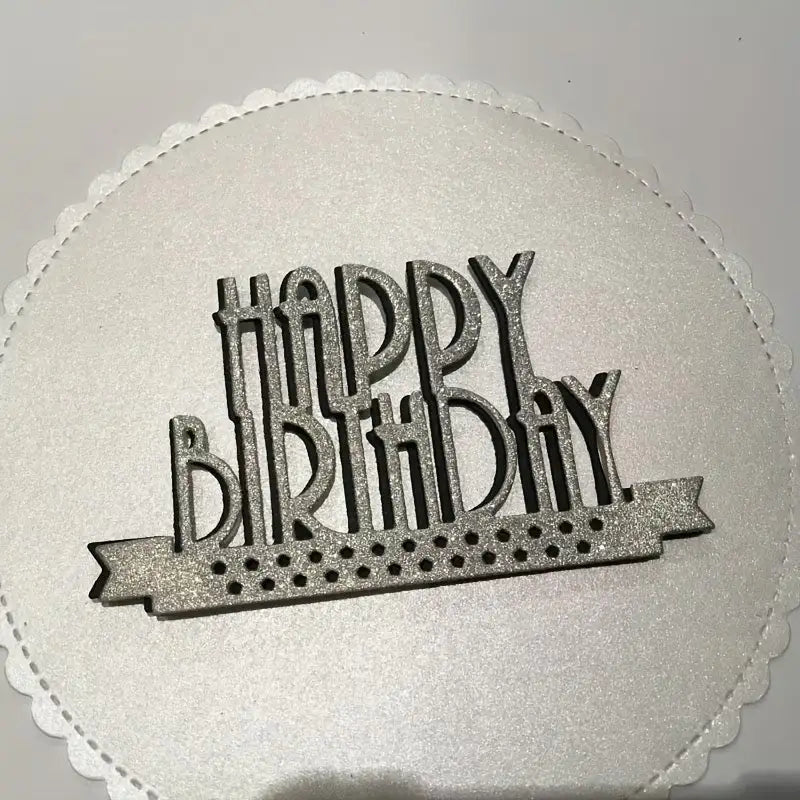 A Happy Birthday Sentiment Cutting Die – Art Deco Lettering (1 PC) (W185) from Printable Heaven rests atop a white, scalloped cake board, making it ideal for coordinating with your scrapbooking projects or handmade birthday cards.