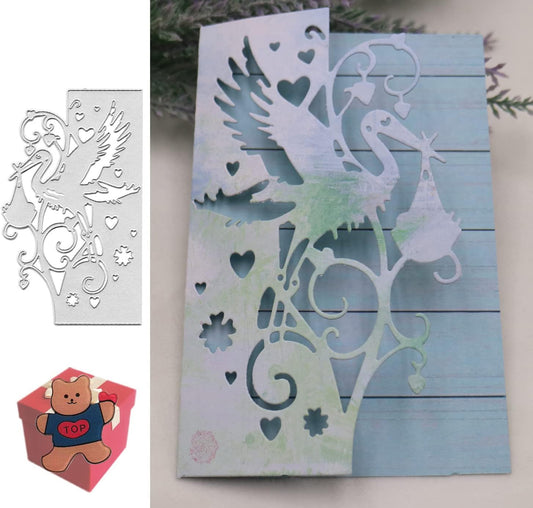 A handmade keepsake, this new baby card features a charming stork and baby cutout design crafted using the Stork Card Front Cutting Die (1 PC) (B130) from Printable Heaven. Displayed beside it is the intricate cutting die itself, while a small red box with a bear illustration labeled “TOP” sits at the bottom left for an added touch of whimsy.