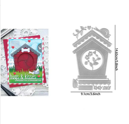 A Printable Heaven Large Cuckoo Clock Cutting Die (13 PCS) (A030), measuring 14.65cm by 9.1cm, features a chalet-style birdhouse adorned with flowers, leaves, and a bird—perfect for crafting intricate card designs with detailed die-cut elements.