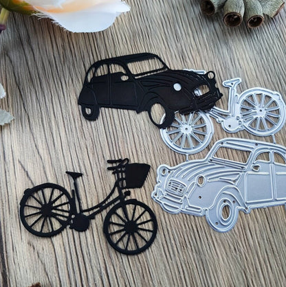 Metal cutouts, crafted using the Printable Heaven Vintage Car & Bicycle Cutting Die (2 PCS) (D103), feature classic car and bicycle silhouettes in striking black and silver hues. Displayed on a wooden surface with dried flowers and plant stems, these pieces capture a sense of timeless charm and nostalgic appeal.