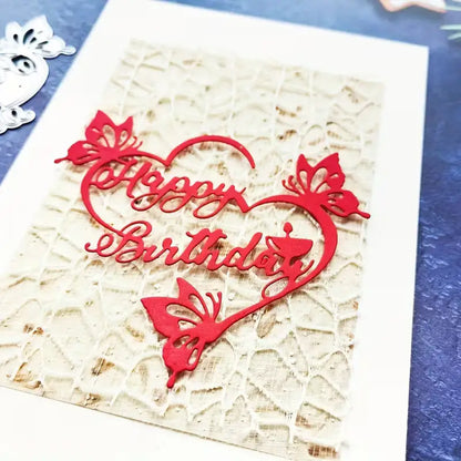 A handmade birthday card featuring a vibrant red “Happy Birthday” sentiment cutout, created with the Printable Heaven Happy Birthday Sentiment Cutting Die - Floral (1 PC) (DJ036). The card is adorned with delicate butterflies and presented on a textured beige background—ideal for anyone who values unique, handcrafted birthday cards and enjoys creative paper craft projects.