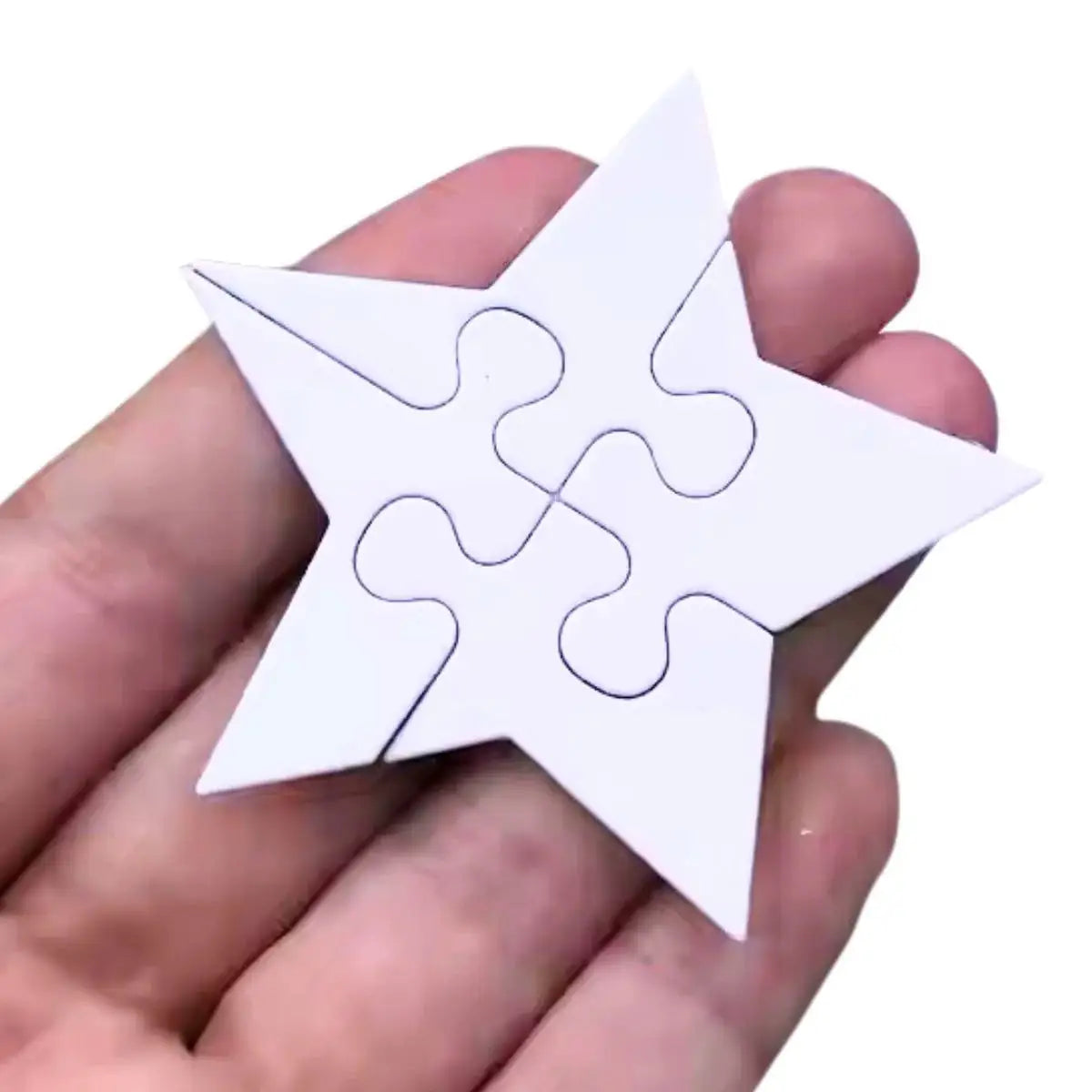 A hand holds a white, star-shaped puzzle assembled from four interlocking pieces—an ideal way to showcase the versatility of your Printable Heaven Jigsaw Puzzle Collection Cutting Die (16 PCS) (T228)—set against a plain white background.