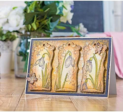 Handcrafted using the Printable Heaven Large Snowdrop Cutting Die (1 PC) (F147), this greeting card is ideal for papercrafting projects. It showcases three panels adorned with illustrated snowdrop flowers and decorative butterflies. The card is photographed on a wooden surface, with softly blurred flowers in the background.