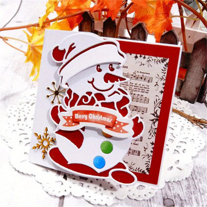 Sure! Here’s a rewritten version using your product data: A handmade Christmas card created with the Printable Heaven Snowman Christmas Cutting Die (1 PC) (P140), featuring a cheerful snowman in a hat and scarf holding a ‘Merry Christmas’ banner, set against a musical sheet and snowflake background. Autumn leaves and a wooden fence complete the wintry scene, making this card ideal for fans of winter-themed paper crafts.