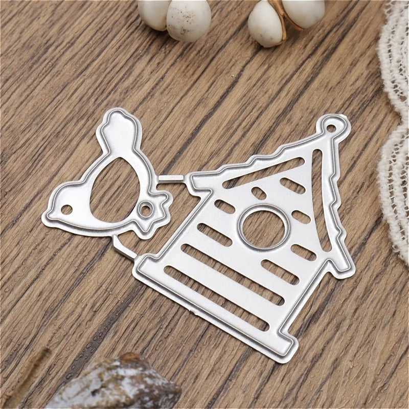 The Birdhouse and Little Bird cutting Die (2 pcs) (A017) by Printable Heaven—featuring a charming bird and birdhouse design—is displayed on a wooden surface with decorative accents nearby, making it perfect for card making or scrapbooking projects.