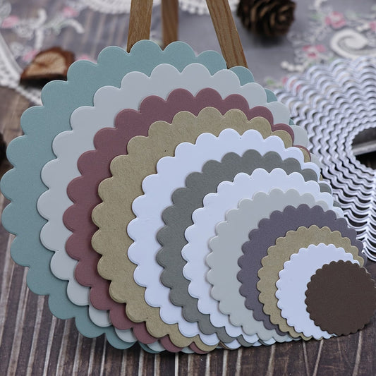 A variety of earth-toned paper circles, cut in multiple sizes using the Printable Heaven 12-Piece Scalloped Circle Cutting Die Set (D140), are layered and fanned out on a wooden surface—perfect for scrapbooking or cardmaking—with additional crafting supplies visible in the background.