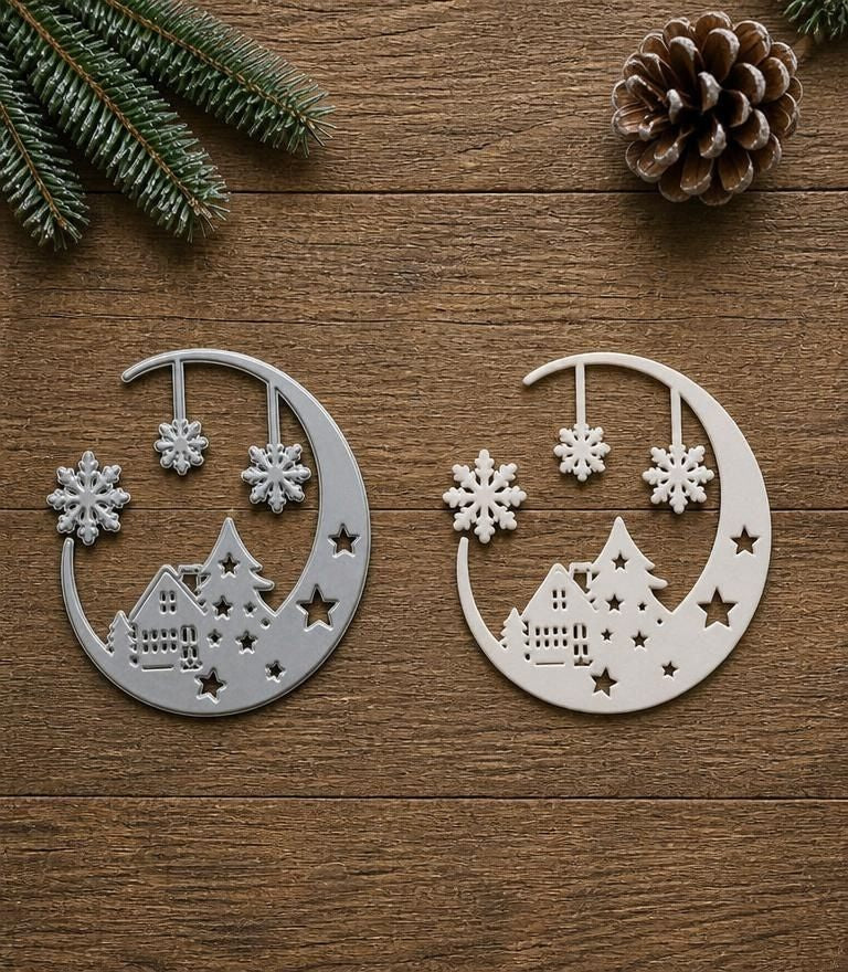 Two metallic ornaments, each adorned with stars, trees, hanging snowflakes, and enchanting winter village scenes, rest upon a wooden surface. Pine sprigs and a pinecone accent the scene’s corner. Perfect for Christmas papercraft or winter cardmaking projects, these ornaments capture the festive charm inspired by Printable Heaven’s Moonlit Winter Village Cutting Die (1 PC) (SP010).