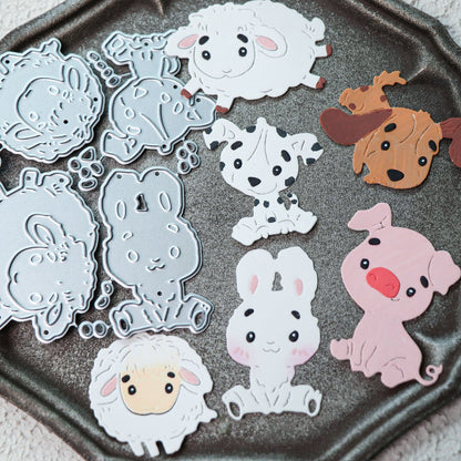 A tray with the Printable Heaven Cute Kawaii Animal Character Cutting Die Set (6 pcs) (A057) features adorable metal dies shaped like a lamb, puppy, rabbit, and pig, along with vibrant paper cutouts—all in a charming cartoon style—perfect for creative paper crafting projects.