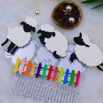 Four sheep and lamb-shaped cutting dies from the Printable Heaven “Trio of Little Lambs with Picket Fence Border (4pcs) (A063)” set are arranged on a furry background, with a vibrant mini picket fence and a dried orange slice adorned with two pearls nearby—ideal inspiration for Easter cards or charming farmyard-themed crafts.