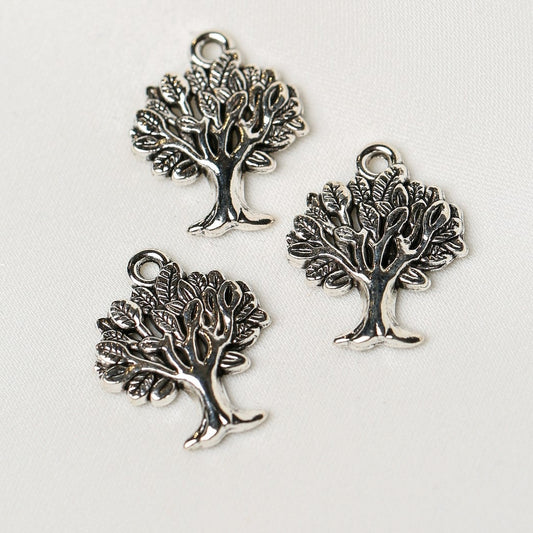 Three silver-toned Tree Metal Charms (3pcs) (MLB-076), each shaped like a tree with a small loop for hanging.