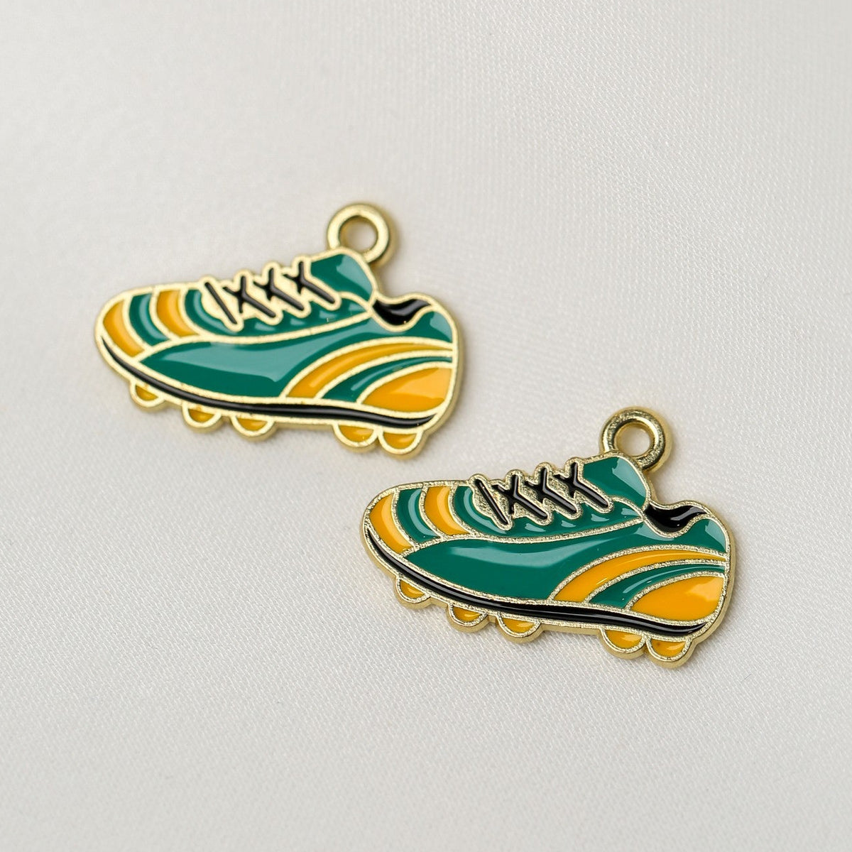 Trainer Metal Charms (2pcs) (MLB-079) shaped like athletic sneakers in green and yellow with gold-tone outlines.