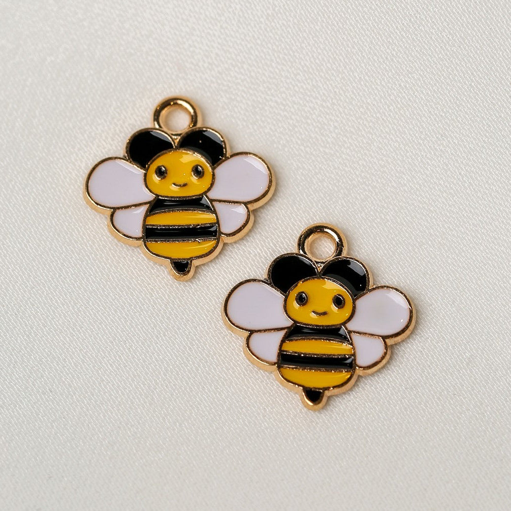 Two Smiling Bee Metal Charms (2pcs) (MLB-085) featuring gold-tone metal bee charms with black and yellow striped bodies and white wings.