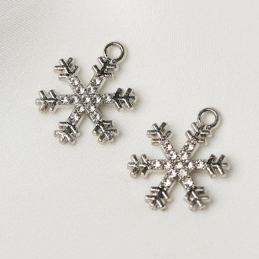 Two silver-toned Star Snowflake Metal Charms (2pcs) (MLB-098) encrusted with small clear crystals.