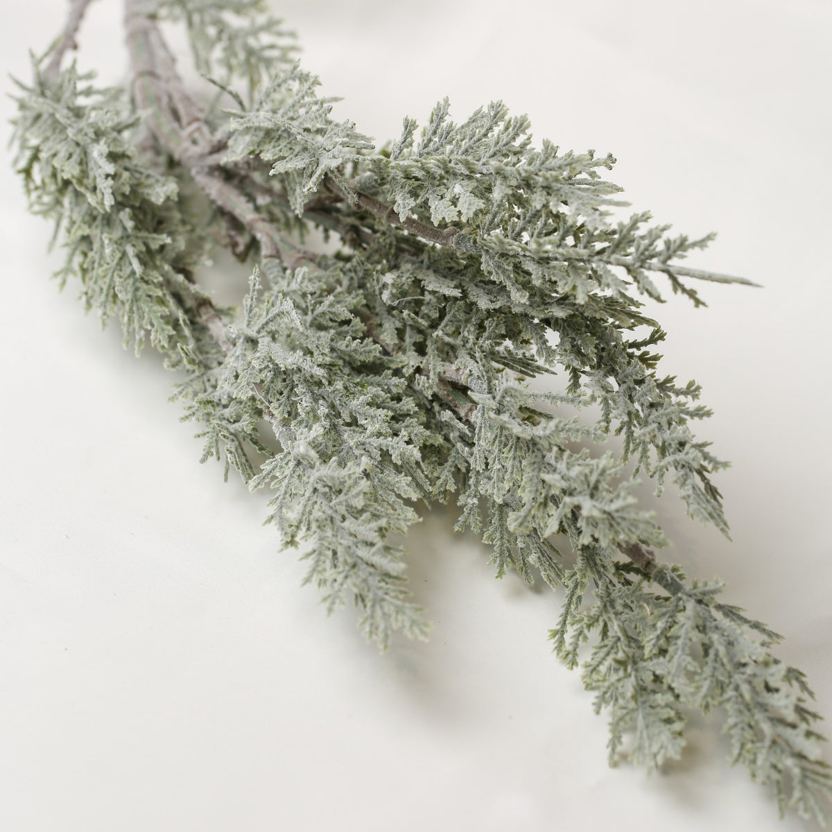 Printable Heaven Faux Frosted Leaf Springs 26″ length, an artificial evergreen branch coated in a dusting of white frost.