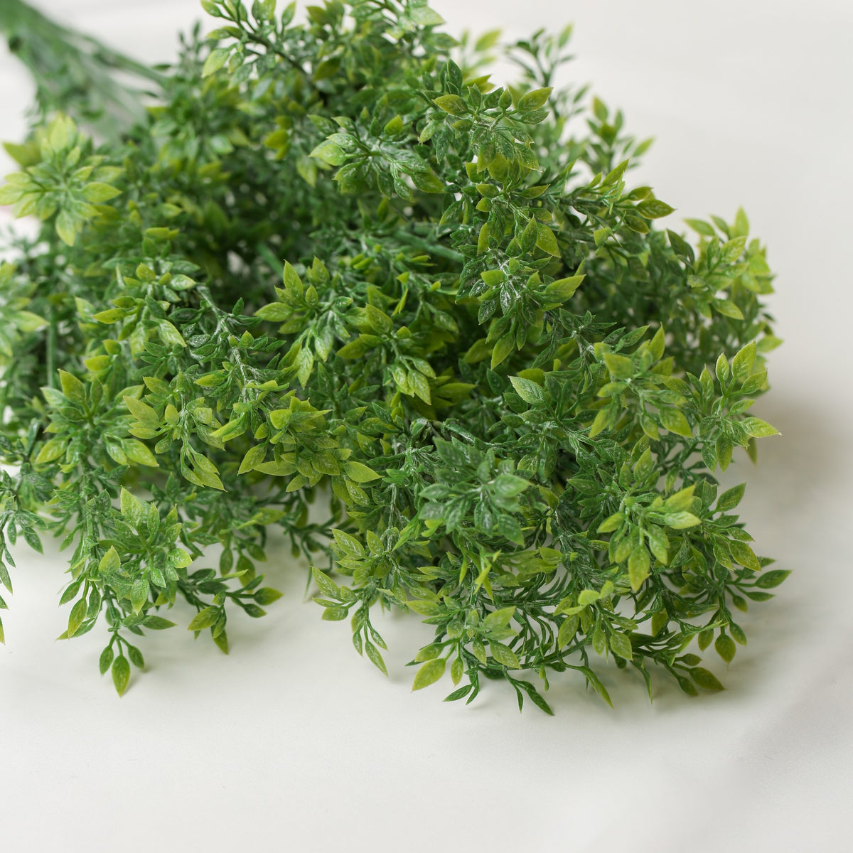 A bunch of green Printable Heaven Faux Leaf Sprigs (18.5″ Length).