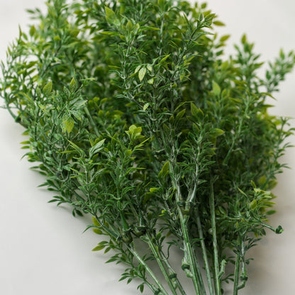 A bunch of Printable Heaven Faux Leaf Sprigs (18.5″ Length) on a white surface.