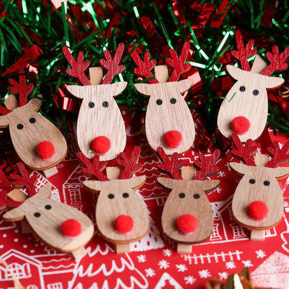 The Printable Heaven Rudolph And Red Nose Clips 8 Pack (XMA4027) features wooden clips with red noses and antlers—ideal for Christmas crafts or any fan of Rudolph the Red-Nosed Reindeer.