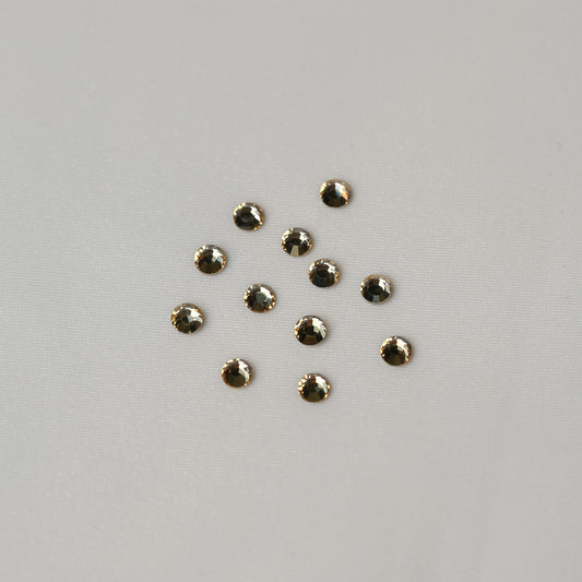 Ten small, round, faceted SS12 Non-Hot Fix Silver Foiled Crystals in Golden Shadow by Printable Heaven arranged in a loose cluster.