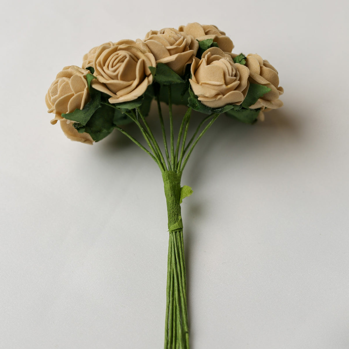 A bunch of Printable Heaven Small Foam Rose Bunch in Beige (1″ Wide) featuring beige foam roses with green wire stems and fabric leaves.