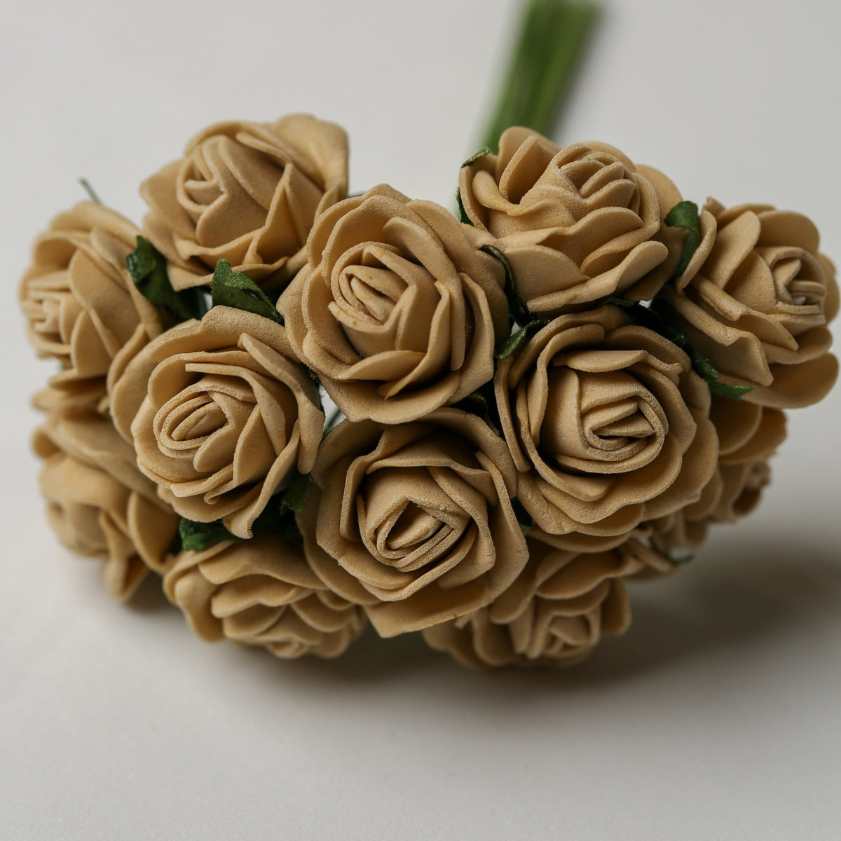 A bunch of Printable Heaven Small Foam Rose Bunch in Beige (1″ Wide) featuring small beige foam roses with green stems.