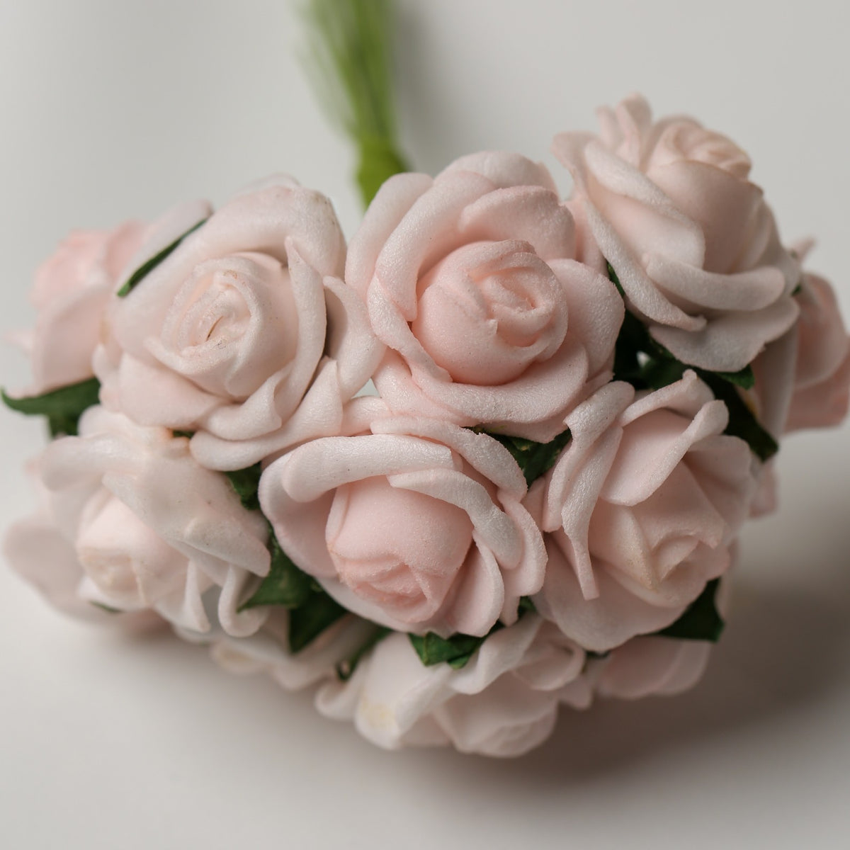 A bunch of Printable Heaven Small Foam Rose Bunch in Light Pink, featuring small, light pink foam roses that are 1″ wide.