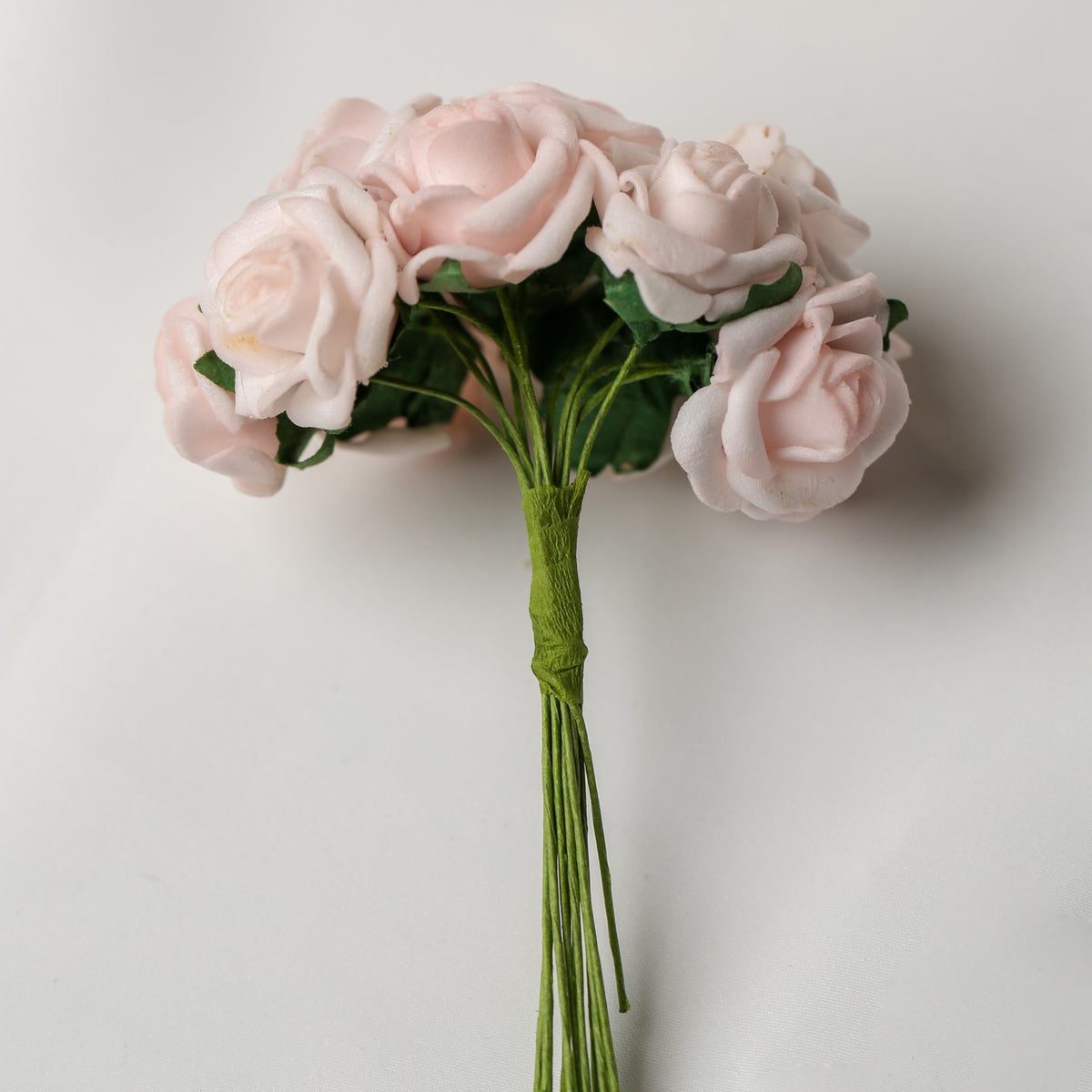 A bunch of Printable Heaven Small Foam Rose Bunch in Light Pink (1″ Wide) featuring small, light pink foam roses on green wired stems.