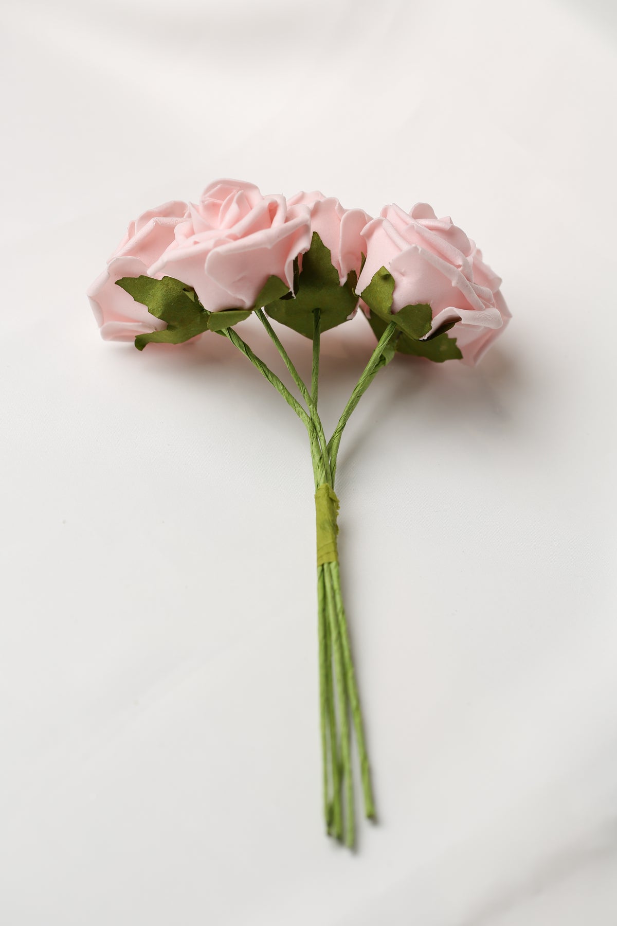 Three light pink Printable Heaven Large Foam Rose Bunch in Vintage Pink roses on thin green stems bound together.