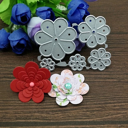 The Flower Cluster Cutting Die (5 PCS) (F053) by Printable Heaven is displayed together with flower embellishments and two handmade paper flowers—one in red and one with a floral pattern accented by a blue gem—arranged on a wooden surface. Behind them, a bouquet of artificial purple and white flowers enhances the appealing world of paper crafting.